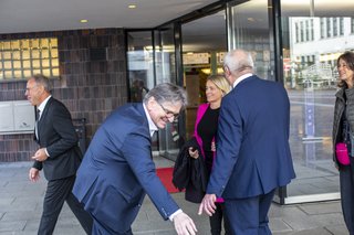 Menschen am Eingang der Liederhalle, darunter Minster Manfred Lucha im Vordergrund, hinter ihm Verena Bentele.