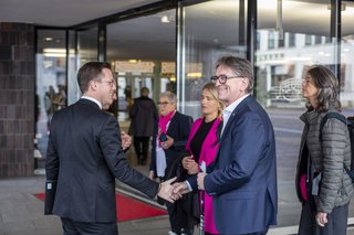 Menschen am Eingang der Liederhalle und begrüßen Verena Bentele.