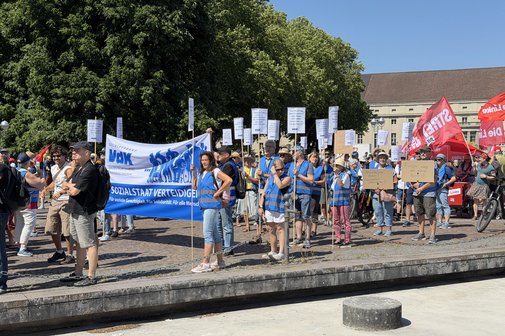Demonstrationszug mit Fahnen und Bannern zieht durch die Stra&szlig;en von Karlsruhe.
