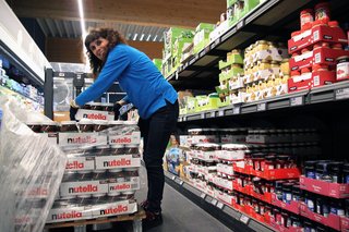 Renate Lüdke in den Gängen des Supermarkts beim Verräumen der Ware.