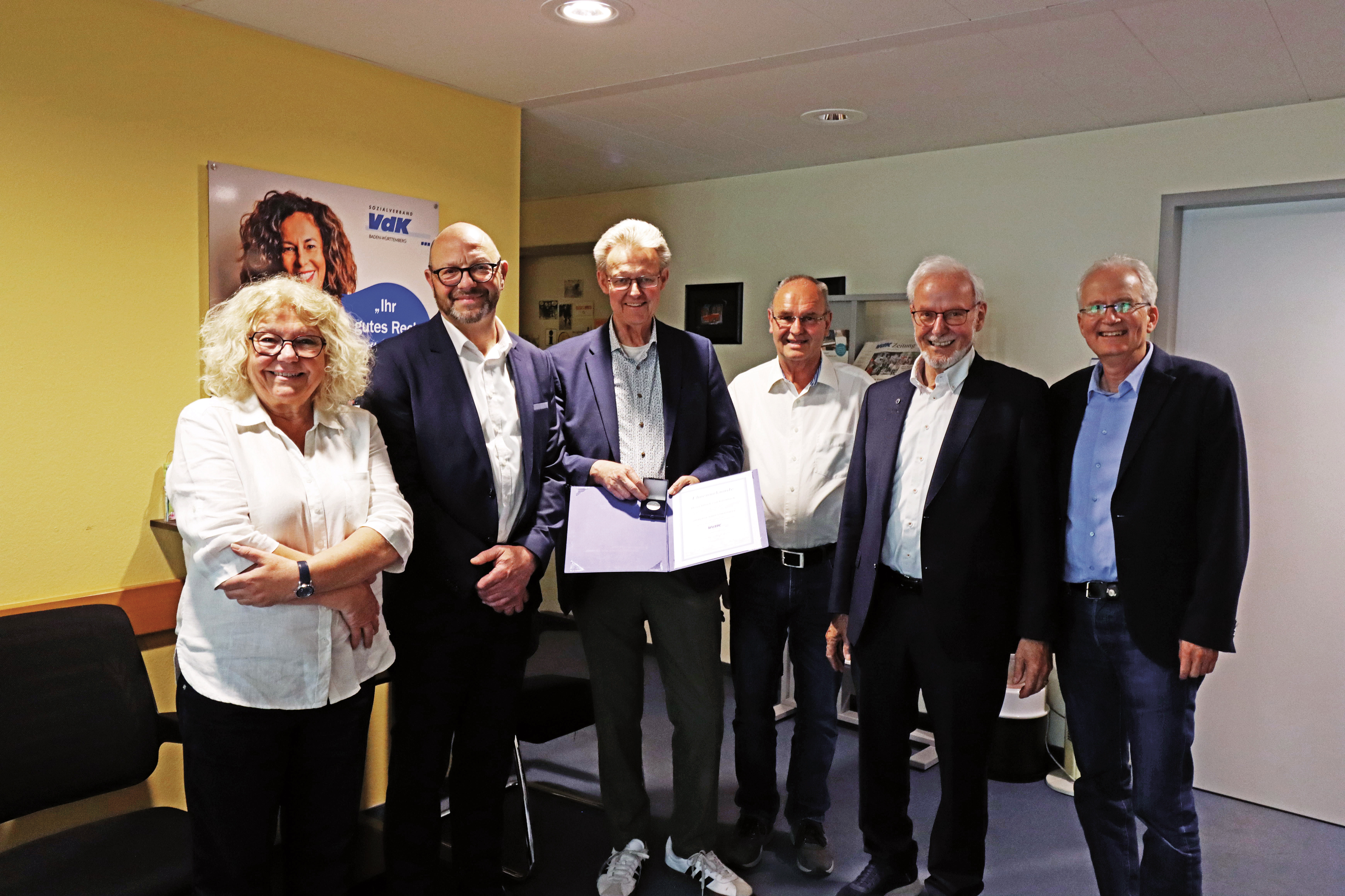 Aufnahme des Geehrten Ullrich von Kirchbach mit seinem Nachfolger Roland Meder in der der VdK-Beratungsstelle Freiburg, rechts und links neben ihnen stehen Frauenvertreterin Marlene Foser-Oberle, VdK-Kreisvorsitzender Werner Widmann sowie Bezirksvorsitzender Ernst Schilling und Bezirksgesch&auml;ftsf&uuml;hrer Klaus-Martin Weih.