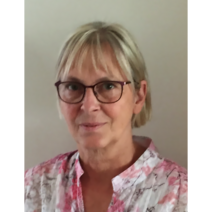 Frau mit silberfarbenen Haaren und einer Brille.