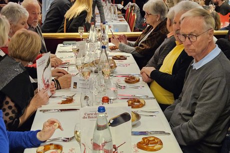 Besucherinnen und Besucher im Saal der Royal Palace Music Hall an den gedeckten Tischen