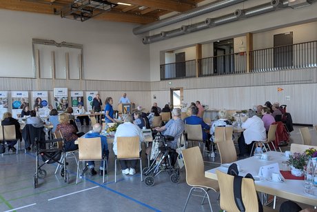 Die Mitglieder an den Tischen sitzend lauschen der Rede von Manfred Merstetter